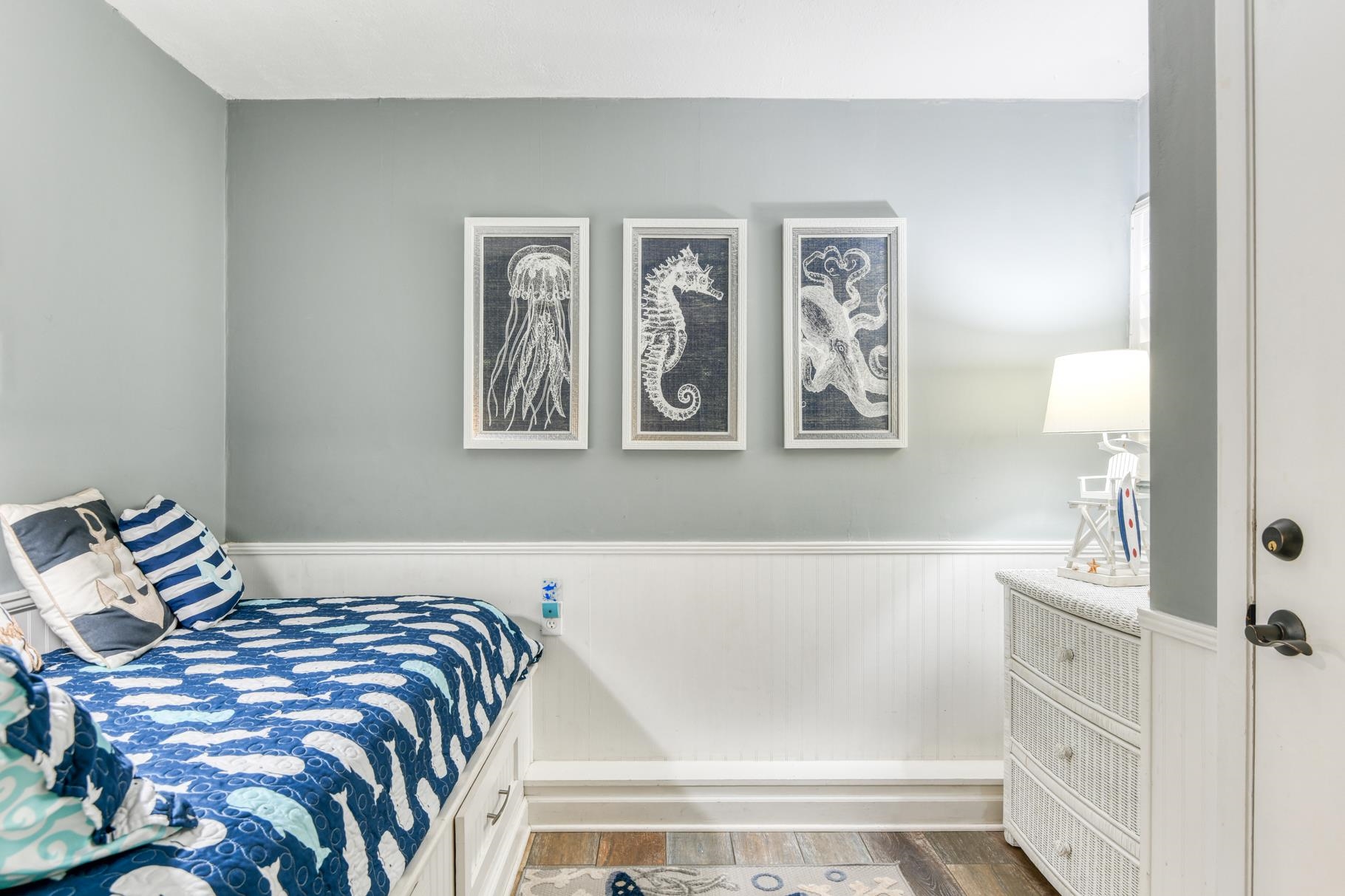 4670 A1A South, Unit 1402 St. Augustine, FL 32080 - Photo 26 of 47 a bedroom with a bed and painting on the wall