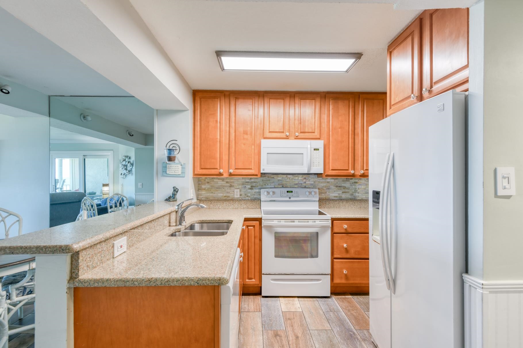 4670 A1A South, Unit 1402 St. Augustine, FL 32080 - Photo 5 of 47 a kitchen with stainless steel appliances granite countertop a sink stove and refrigerator