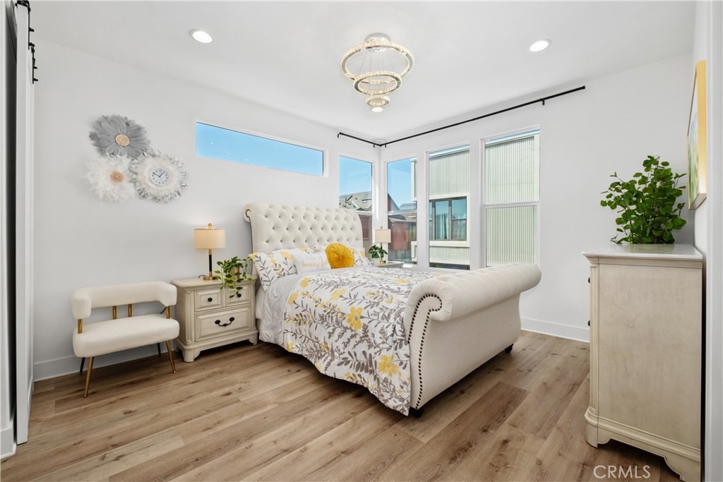 154 Keeper Irvine, CA 92618 - Photo 16 of 42 a bedroom with a bed and a chandelier