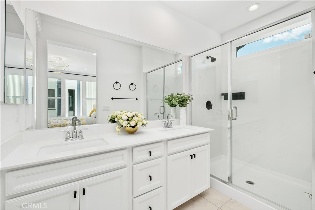 154 Keeper Irvine, CA 92618 - Photo 18 of 42 a bathroom with a shower sink and mirror