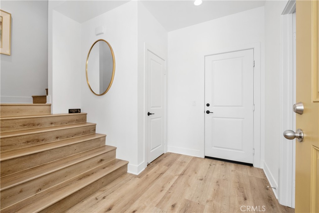 154 Keeper Irvine, CA 92618 - Photo 27 of 42 a view of a hallway with wooden floor and staircase