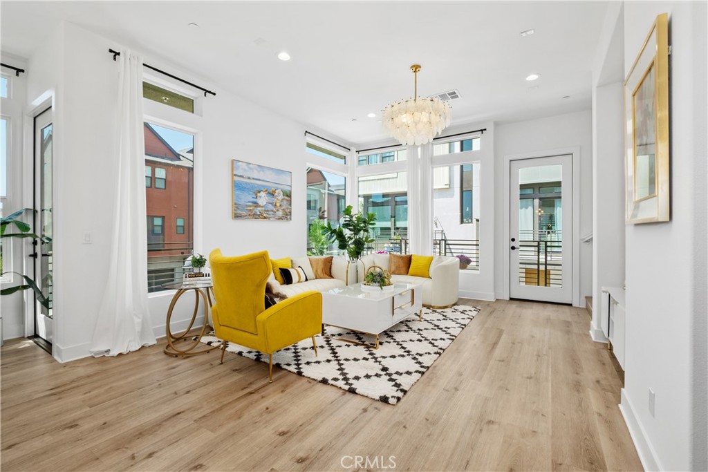 154 Keeper Irvine, CA 92618 - Photo 6 of 42 a living room with furniture two large window and wooden floor