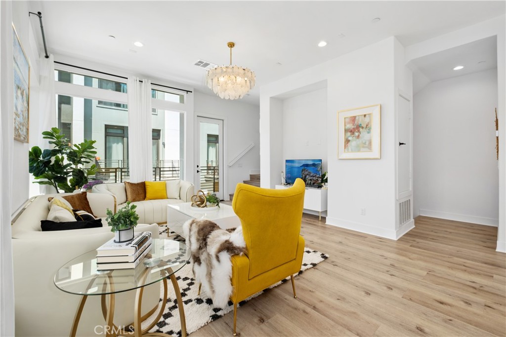 154 Keeper Irvine, CA 92618 - Photo 7 of 42 a living room with furniture kitchen view and a chandelier