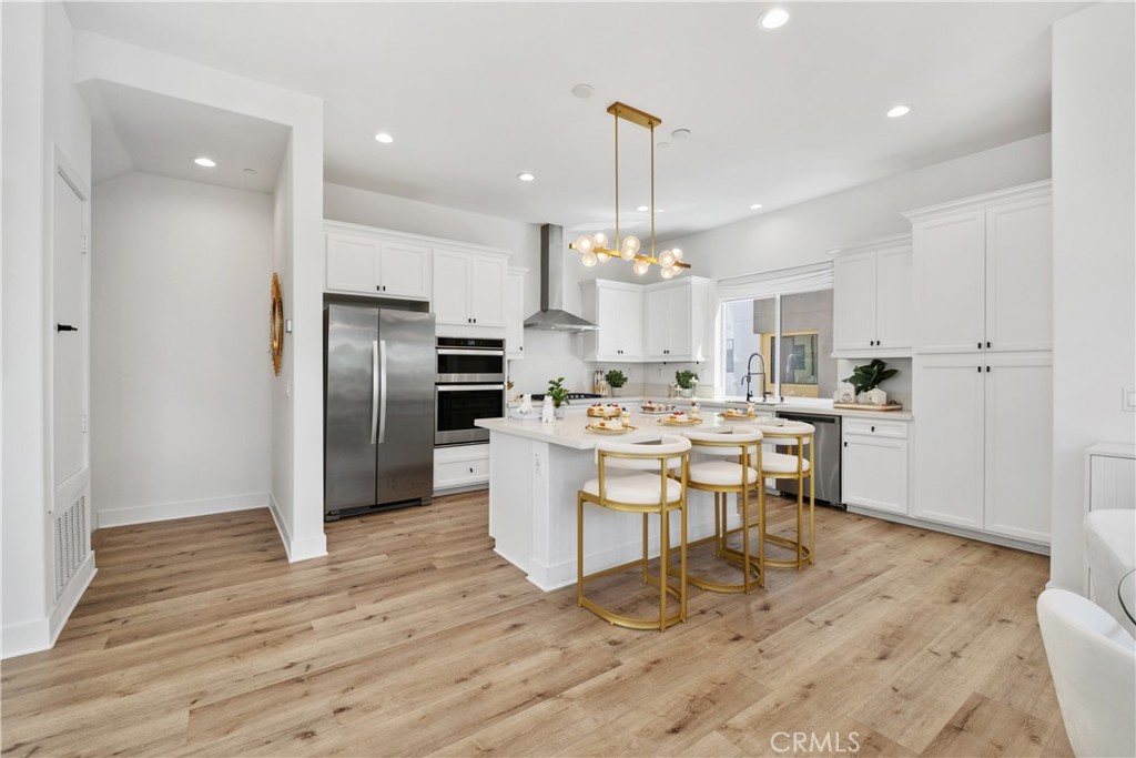 154 Keeper Irvine, CA 92618 - Photo 8 of 42 a kitchen with stainless steel appliances kitchen island hardwood floor sink and stove