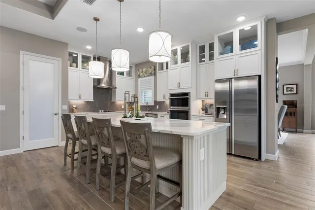 a kitchen with stainless steel appliances a sink and a refrigerator