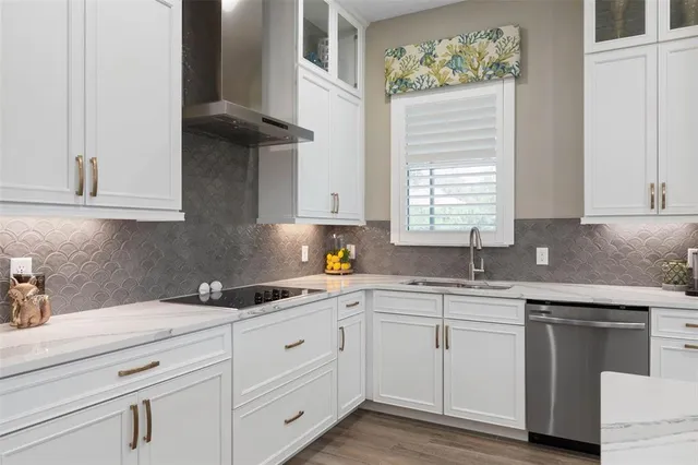 a living room with furniture kitchen view and a large window