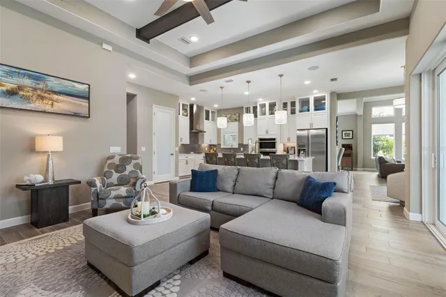 a bedroom with a large bed and wooden floor