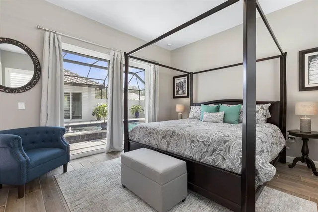 a bedroom with a bed and a painting on the wall