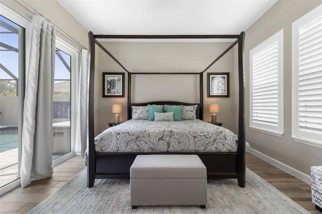 a spacious bedroom with a bed and a painting on the wall