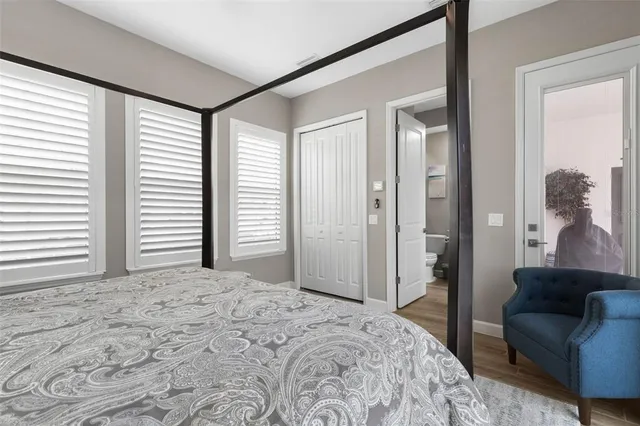 a bedroom with a bed and a flat tv screen