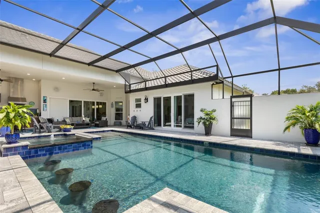 a living room with furniture and large windows