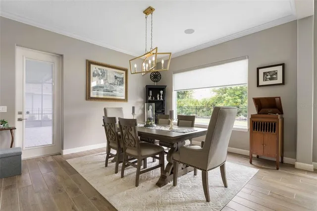 a kitchen with white cabinets and refrigerator