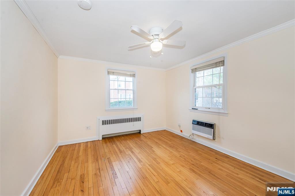 445 Morris Avenue, Unit 7C Springfield, NJ 07081 - Photo 12 of 16 wooden floor in an empty room with a window
