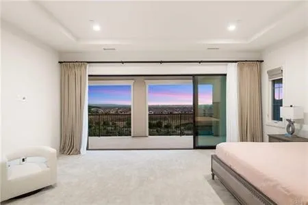 a bed room with a bed and a large window
