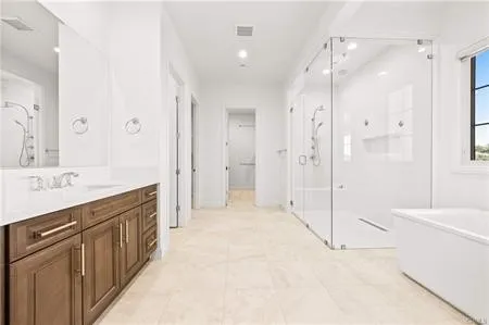 a spacious bathroom with a shower sink and a mirror