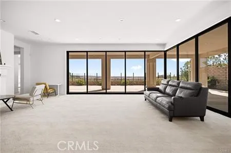 a living room with furniture and large windows