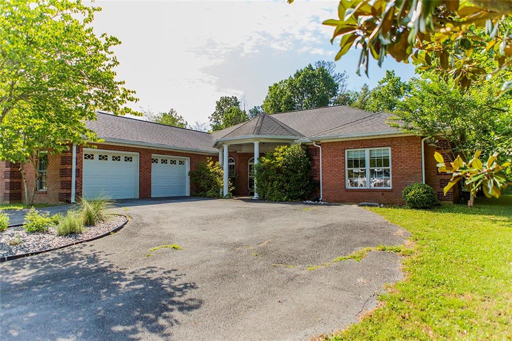 154 Chaucer Place Rome, GA 30161 - Photo 1 of 1 a view of a house with a yard and potted plants