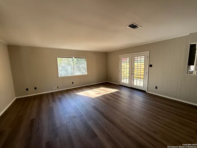 a kitchen with granite countertop a refrigerator and a sink