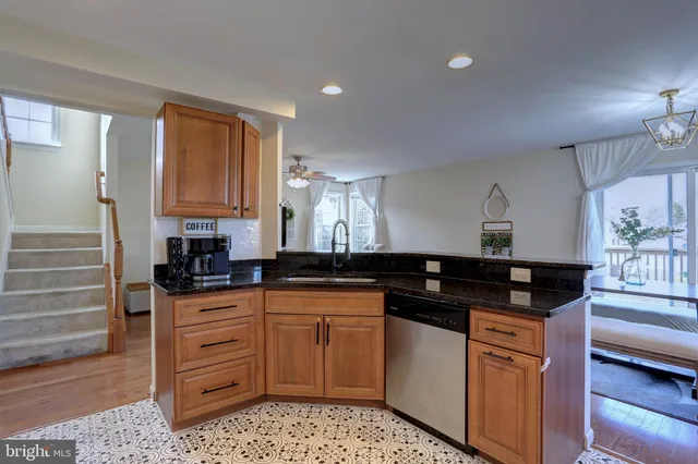 a kitchen with granite countertop a sink and cabinets