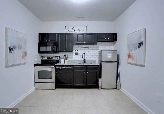 a kitchen with stainless steel appliances a stove microwave and refrigerator