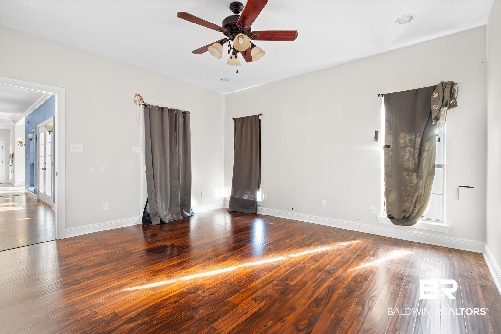 20792 Lonnie Walker Road Citronelle, AL 36522 - Photo 9 of 19 Empty room with ceiling fan and dark hardwood / wood-style flooring