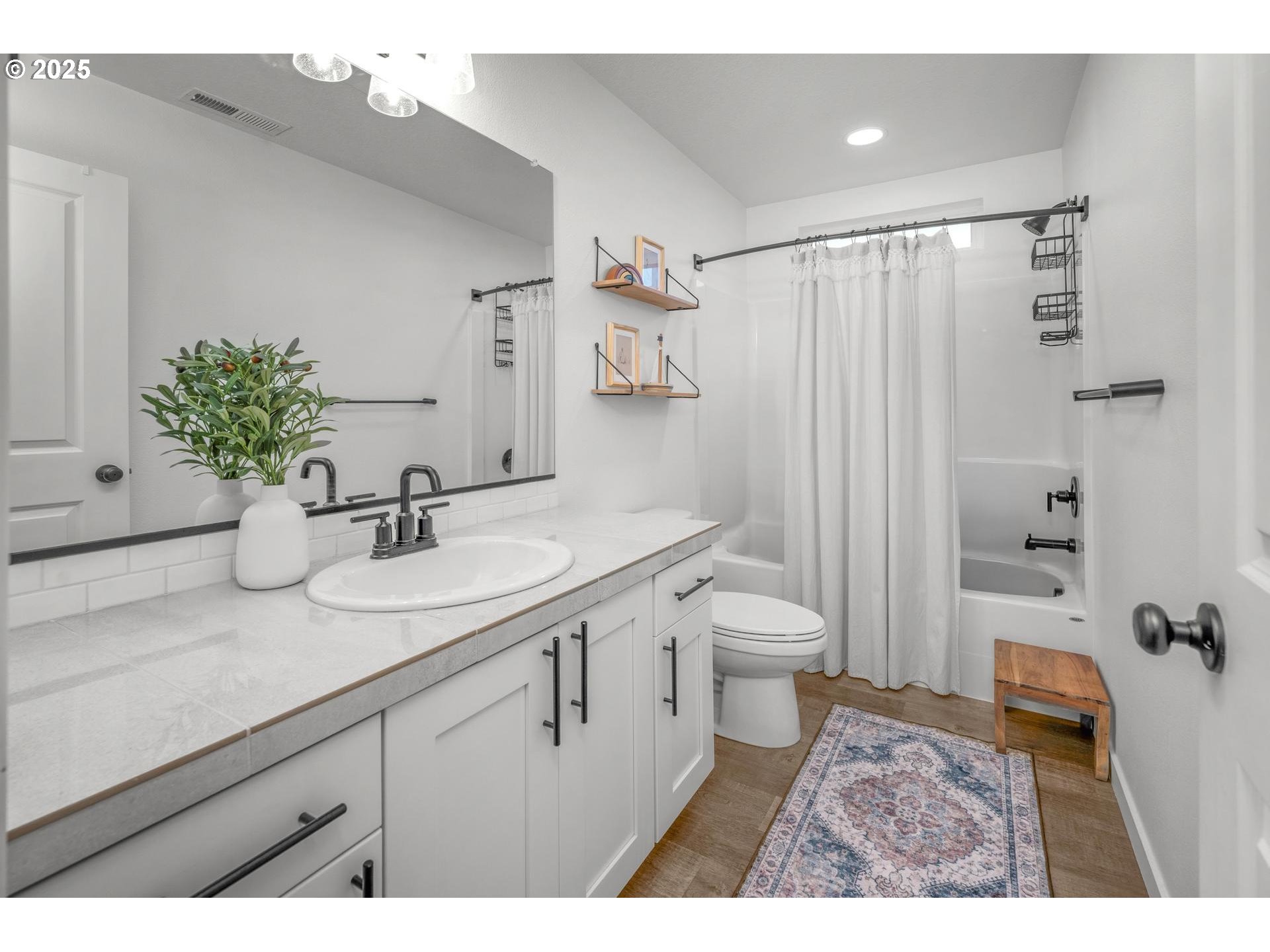 2427 South Linden Street Cornelius, OR 97113 - Photo 28 of 37 a bathroom with a granite countertop sink a toilet a shower and mirror