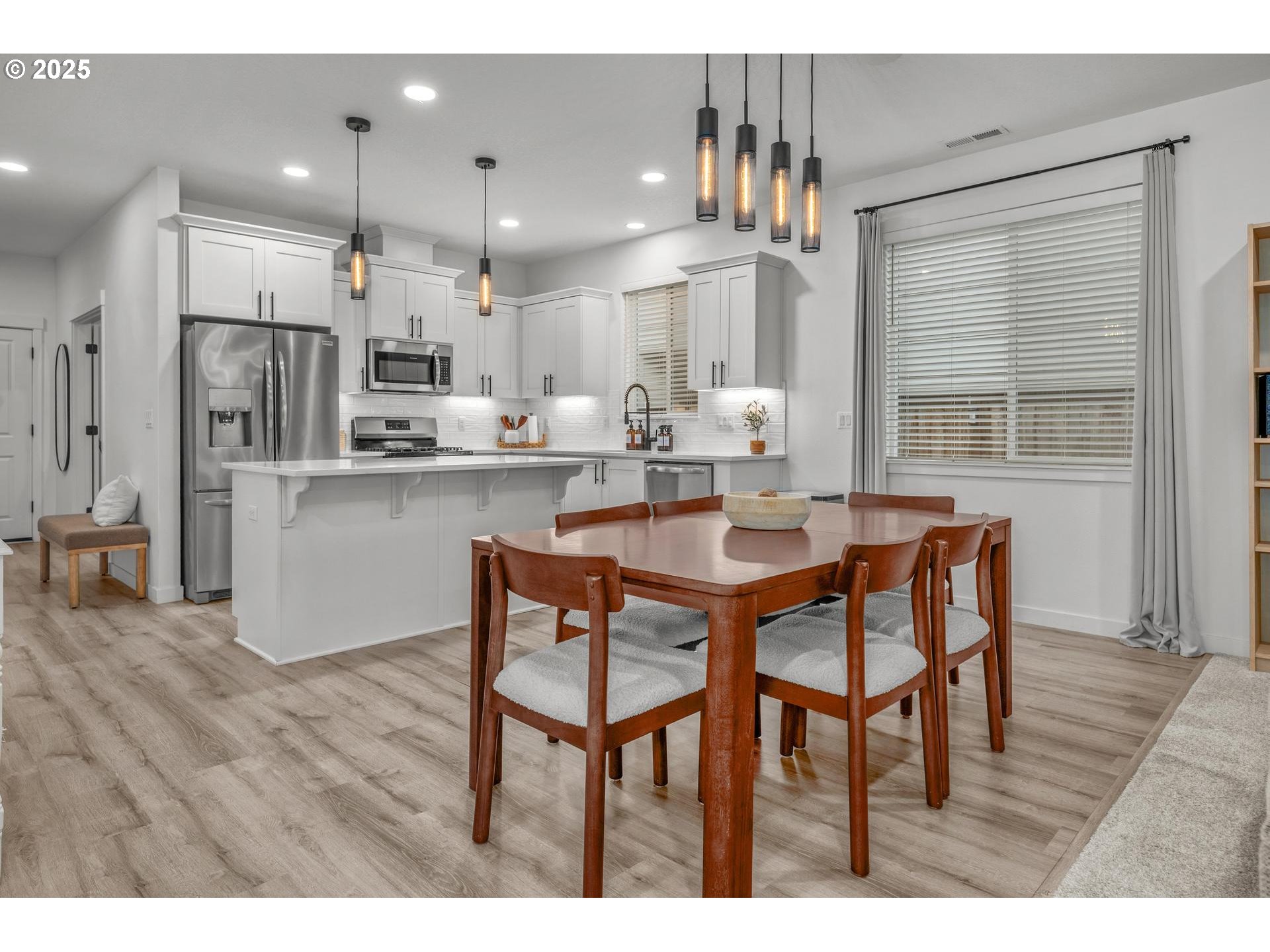 2427 South Linden Street Cornelius, OR 97113 - Photo 4 of 37 a dining room with kitchen island a table and chairs