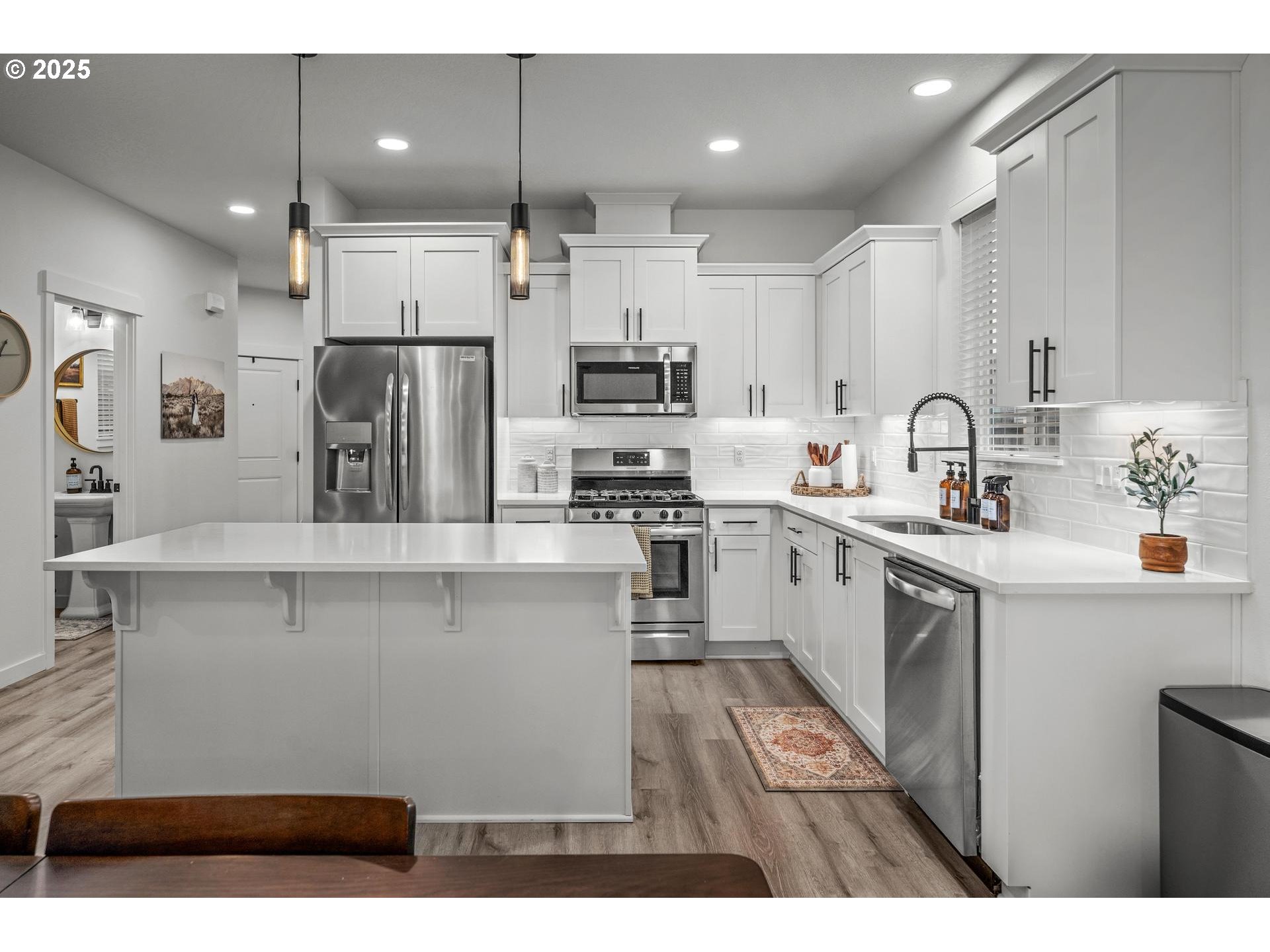 2427 South Linden Street Cornelius, OR 97113 - Photo 7 of 37 a kitchen with kitchen island white cabinets and refrigerator