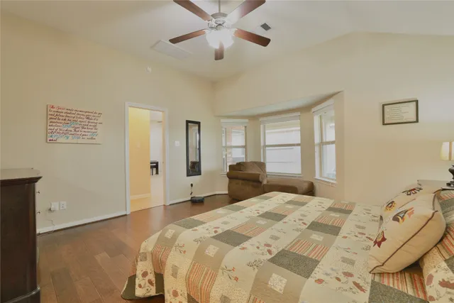 a spacious bedroom with a bed and a couch