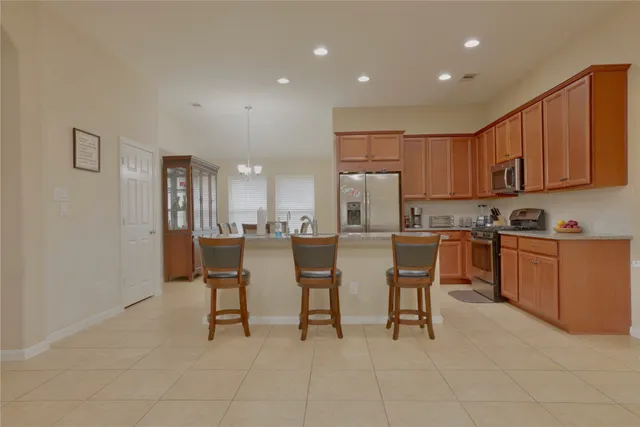 a view of a dining room with furniture and a chandelier