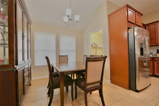 a view of a dining room with furniture and a window