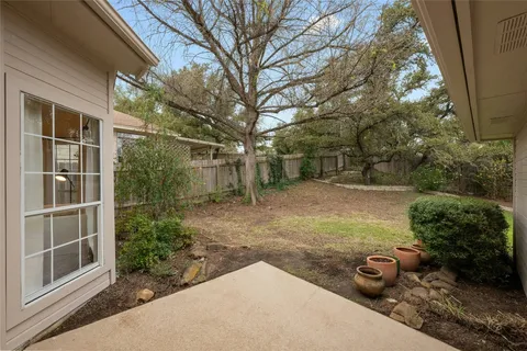 a view of a backyard with table and chairs and potted plants