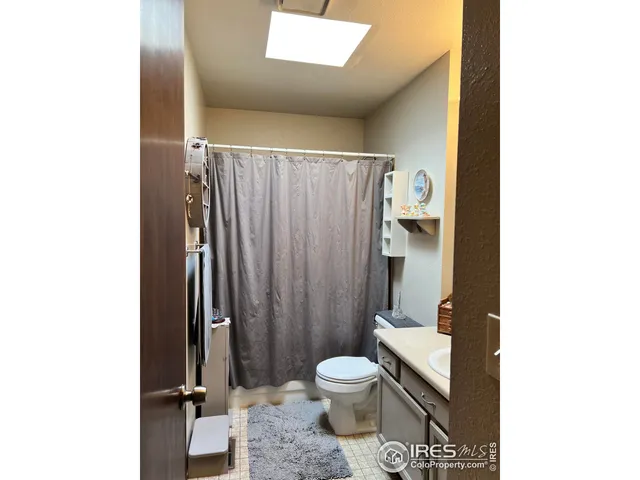 a bathroom with a toilet a sink and shower