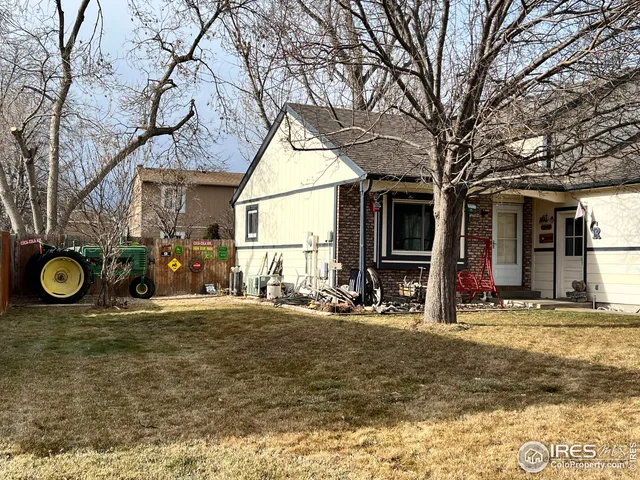 a view of a house with a patio and a yard
