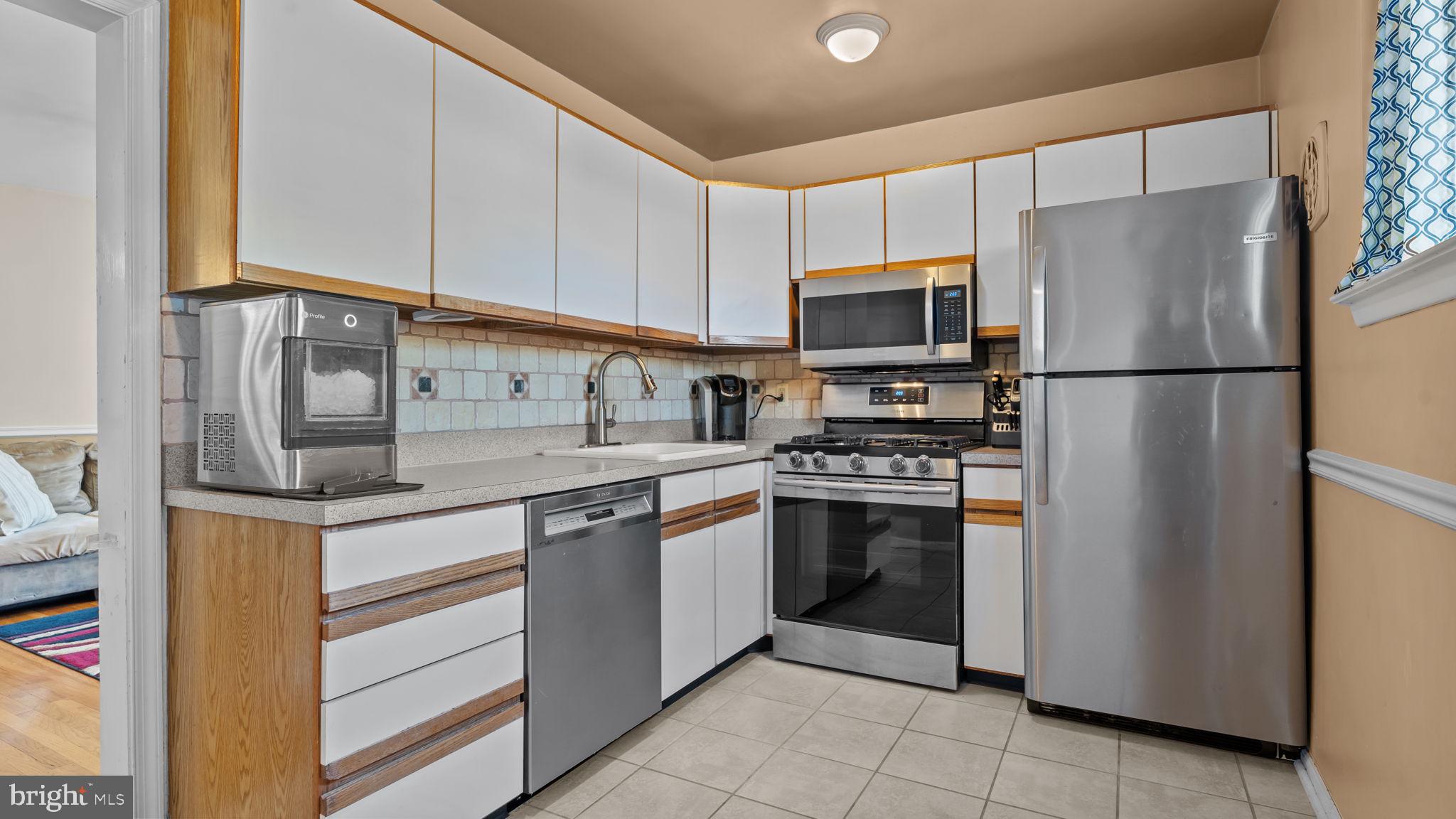 526 Palmer Road Conshohocken, PA 19428 - Photo 8 of 31 a kitchen with stainless steel appliances granite countertop a refrigerator and a stove top oven