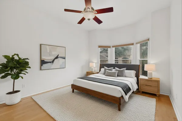 a bedroom with a bed lamp and a potted plant