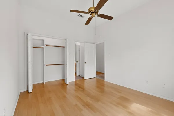 a view of empty room with wooden floor