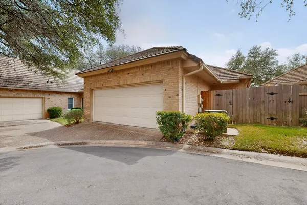 a front view of a house with a yard and a garage