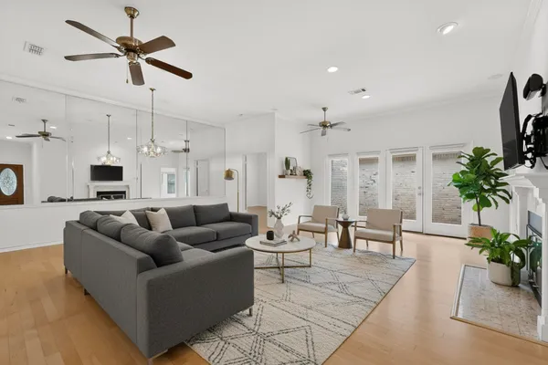 a living room with furniture kitchen view and a potted plant