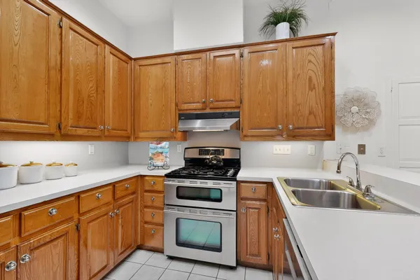 a kitchen with stainless steel appliances a stove a sink a microwave and cabinets