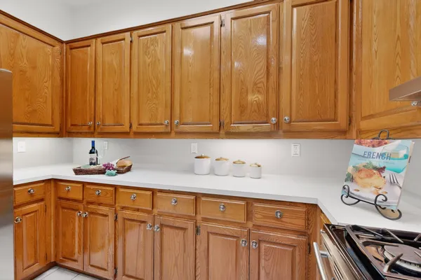 a kitchen with stainless steel appliances a sink cabinets and a window