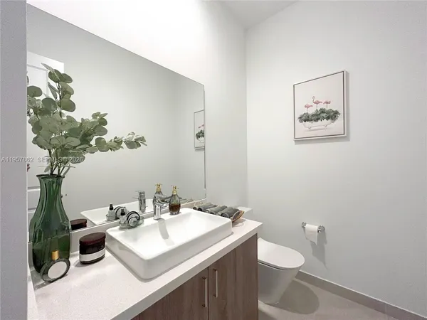 a bathroom with a sink a shower and a mirror