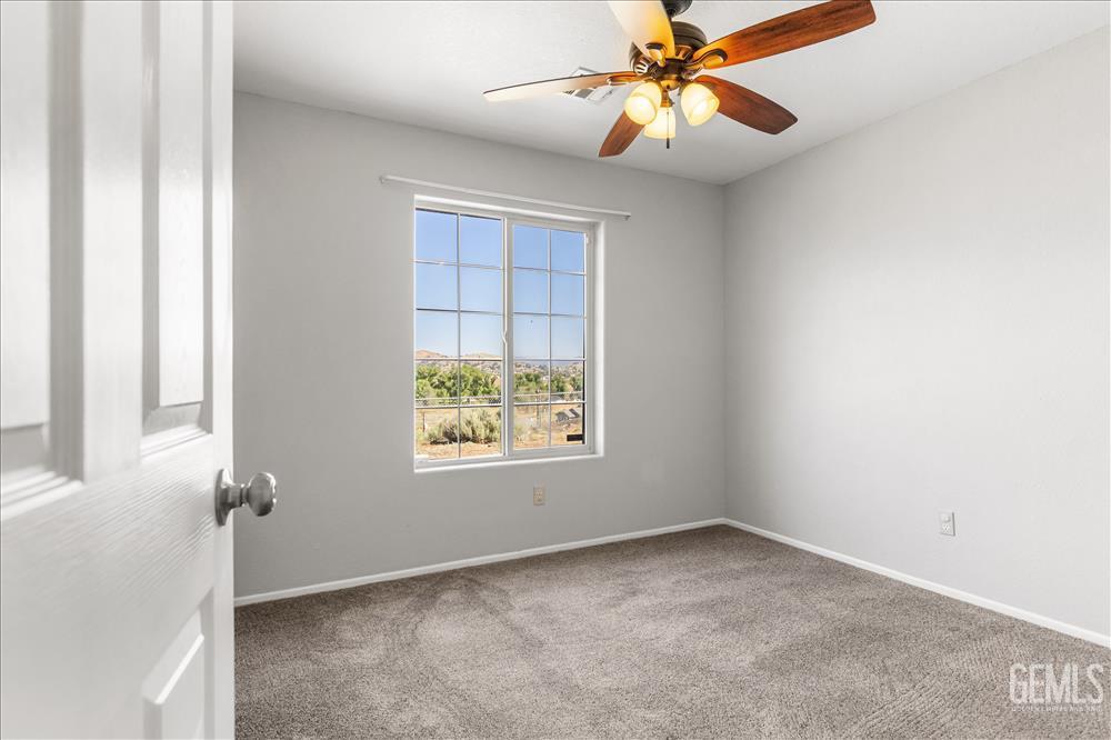 Undisclosed Address Tehachapi, CA 93561 - Photo 14 of 32 an empty room with windows and fan