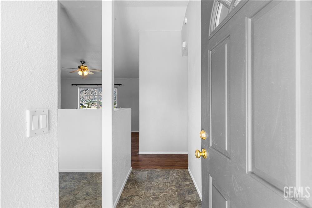 Undisclosed Address Tehachapi, CA 93561 - Photo 2 of 32 a view of a hallway with wooden cabinets