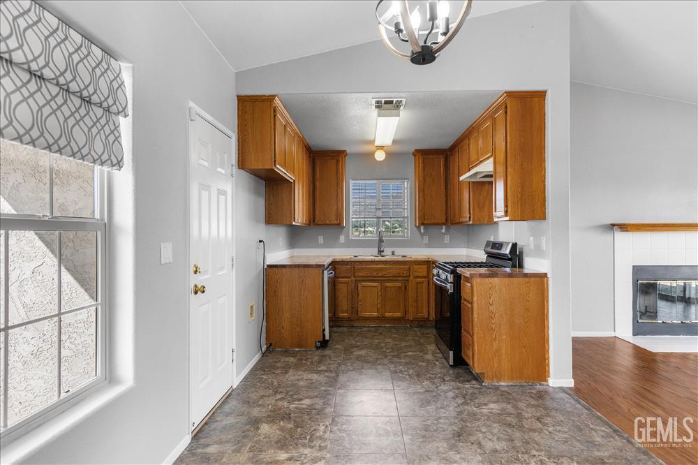 Undisclosed Address Tehachapi, CA 93561 - Photo 4 of 32 a kitchen with stainless steel appliances granite countertop a refrigerator a stove top oven a sink and dishwasher