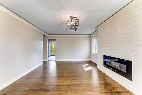 a view of an empty room window and wooden floor