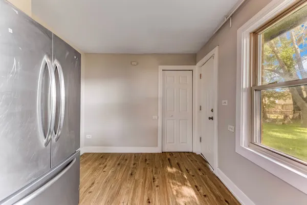 a view of bathroom with window and wooden floor