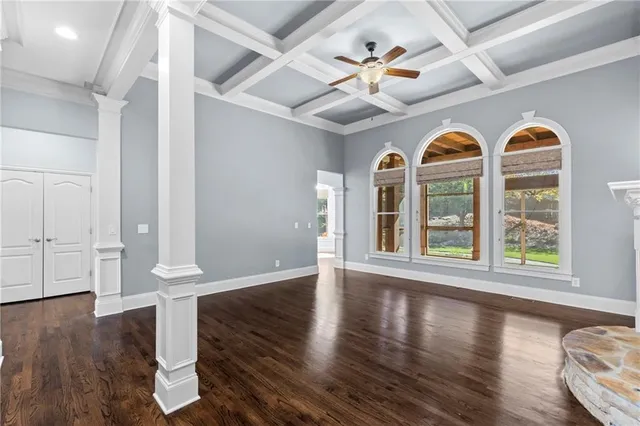 a kitchen with stainless steel appliances granite countertop a stove top oven a sink dishwasher and a refrigerator with wooden floor