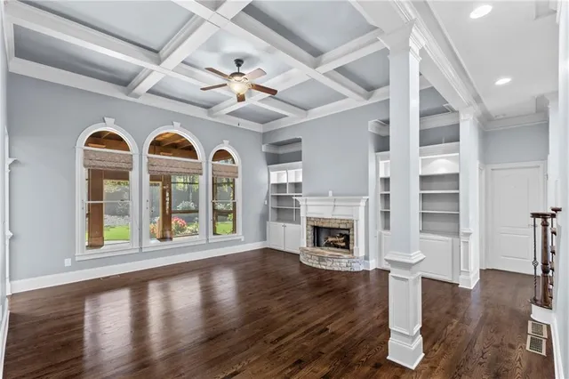 a kitchen with kitchen island white cabinets and stainless steel appliances