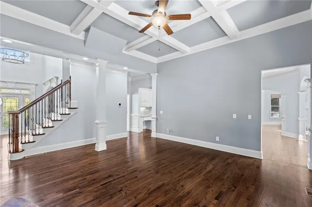 a spacious bathroom with a granite countertop sink and a large mirror next to a window